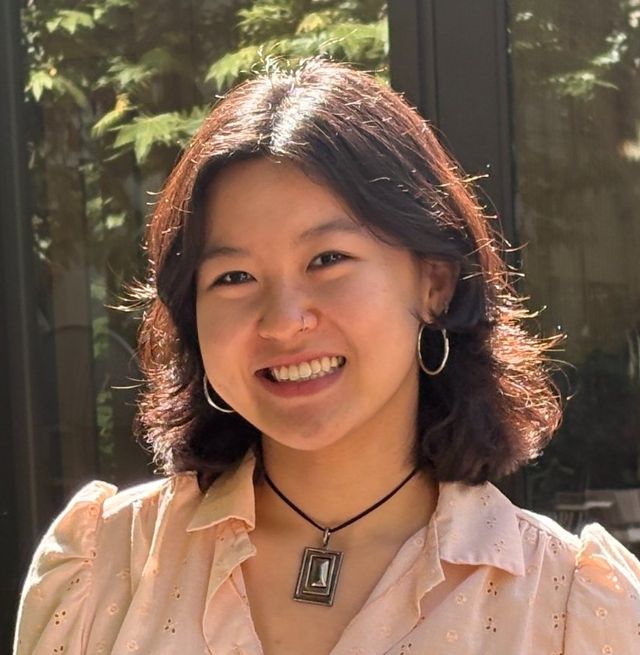 Portrait of Miriam Zhou smiling outdoors in front of trees